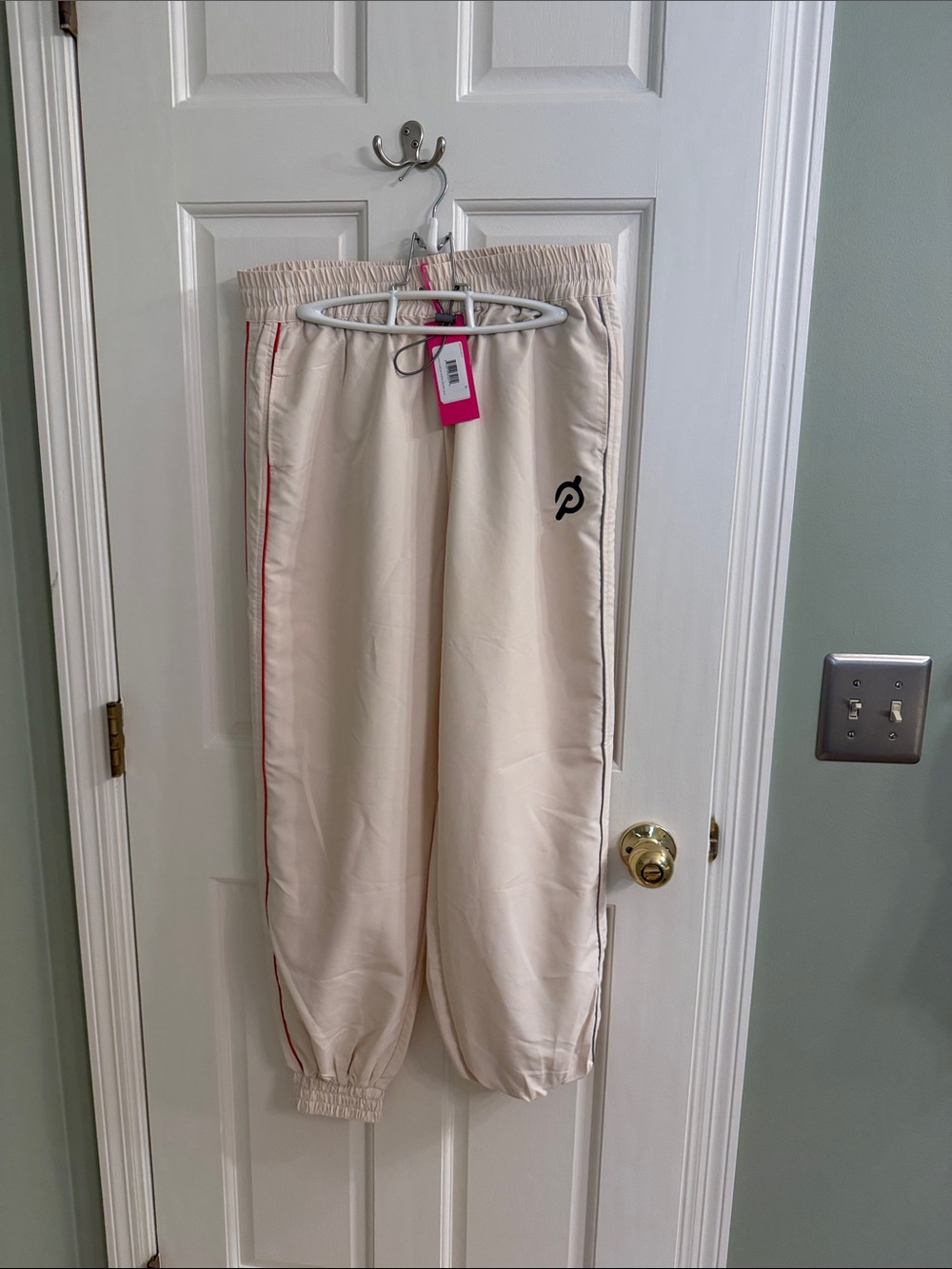 Peloton Cream Track Pants with Red Stripe and Black Logo